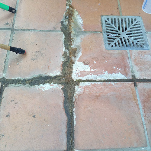 old terracotta tiles with efflorescence - before